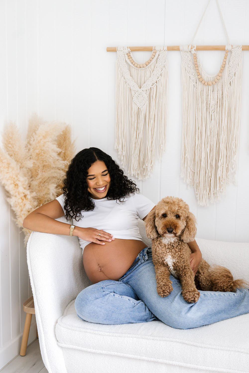 Expectant mother relaxing with her dog during a natural maternity photography session in Nottingham