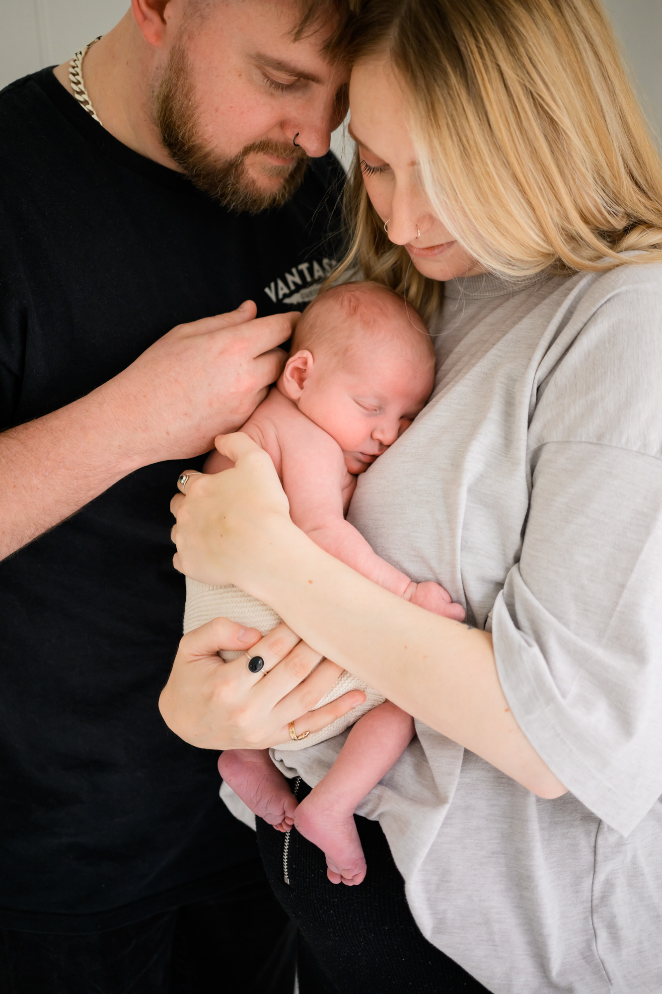 closeup photo of newborn photoshoot showing baby holding hands with mum